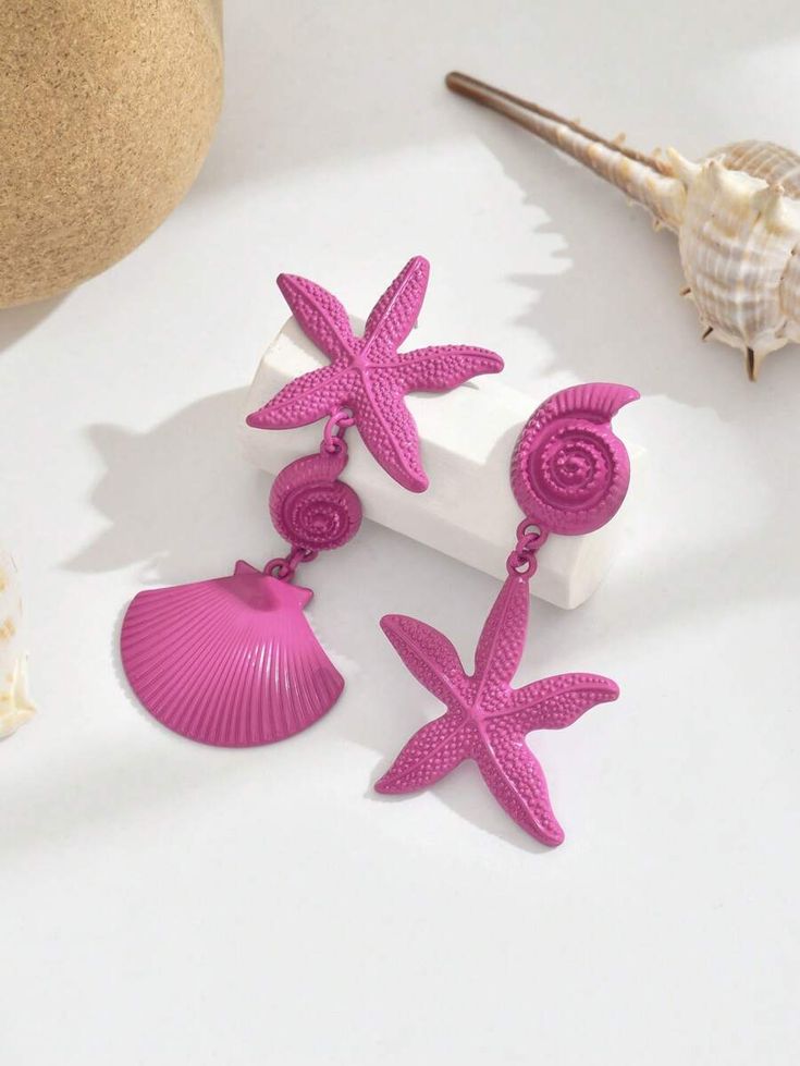 A pair of asymmetrical metal shell and starfish earrings for women in a stylish and practical beach holiday style, suitable for daily wear and festive events.