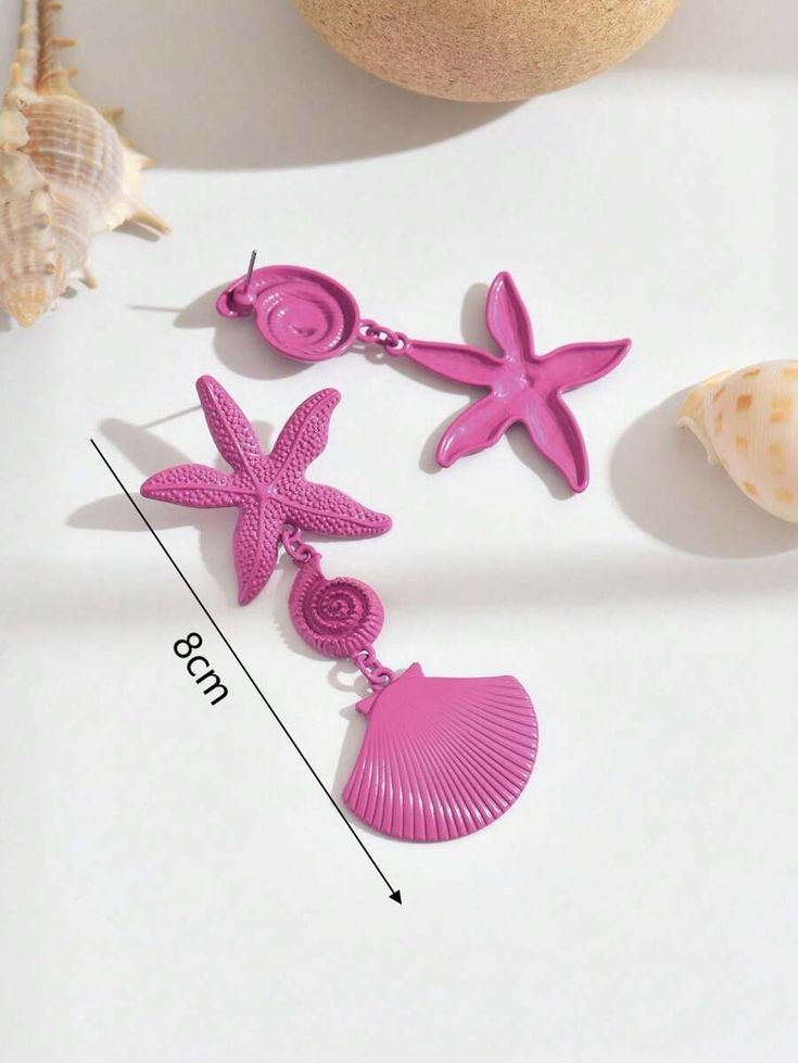 A pair of asymmetrical metal shell and starfish earrings for women in a stylish and practical beach holiday style, suitable for daily wear and festive events.