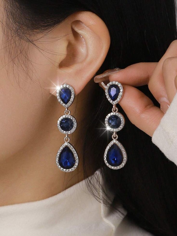 A pair of stylish, modern, bohemian-style earrings made of metal, glass, and rhinestone.