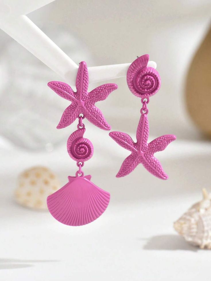 A pair of asymmetrical metal shell and starfish earrings for women in a stylish and practical beach holiday style, suitable for daily wear and festive events.
